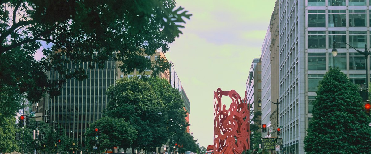 A large red sculpture on the side of a road