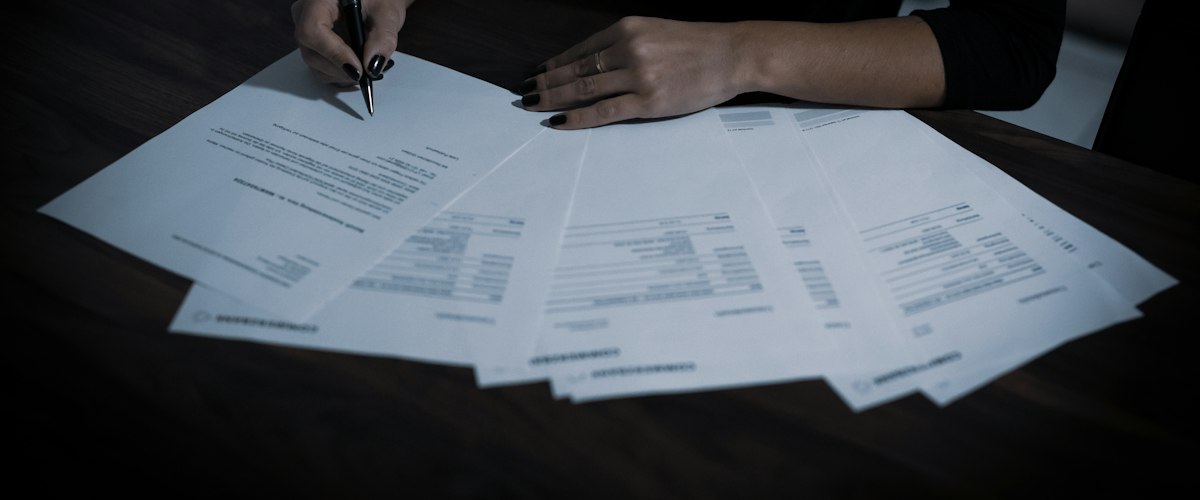 A woman sitting at a table with lots of papers