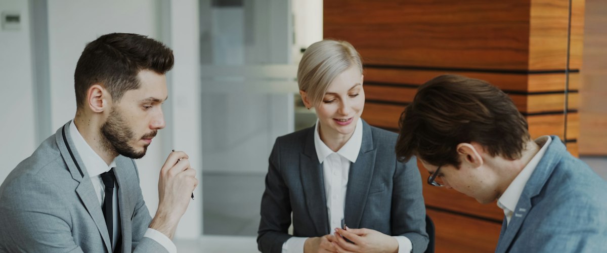 Business people signing a contract at a table