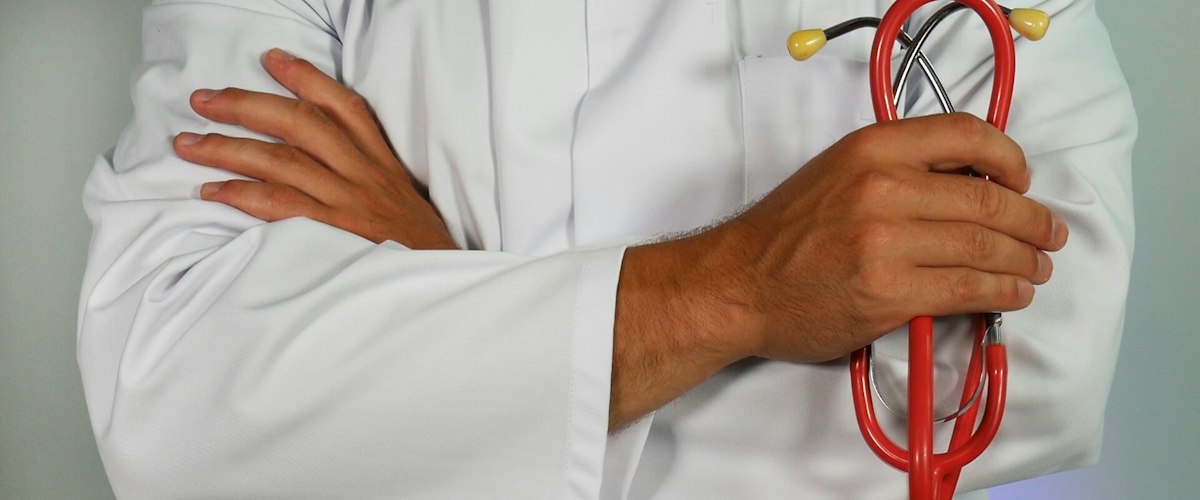 Doctor holding red stethoscope