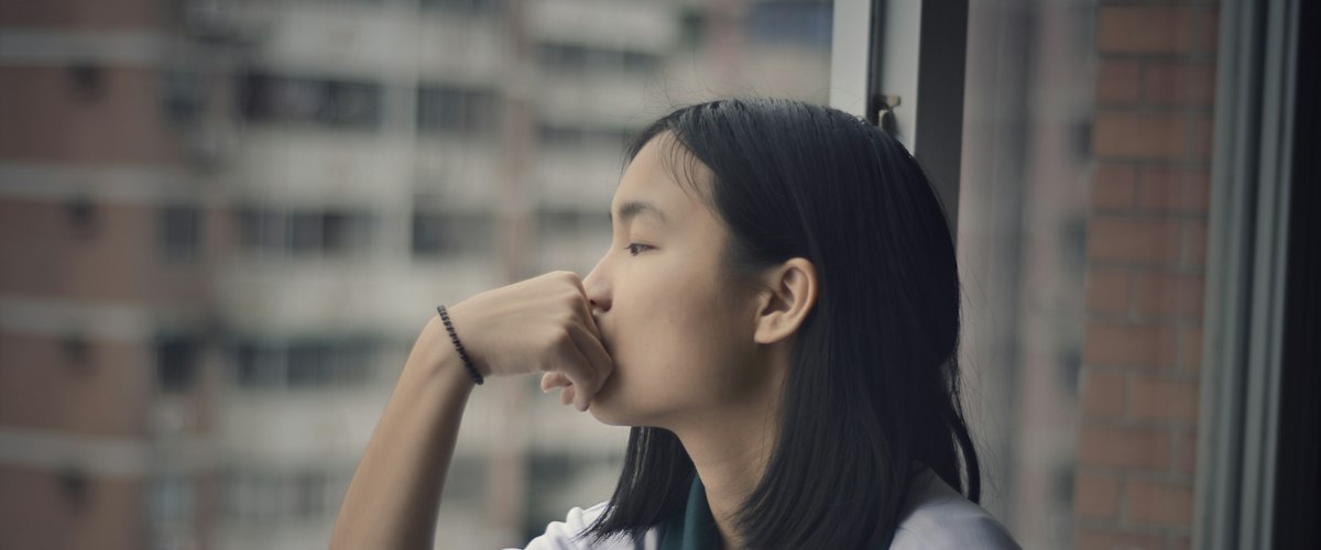 Woman looking through window